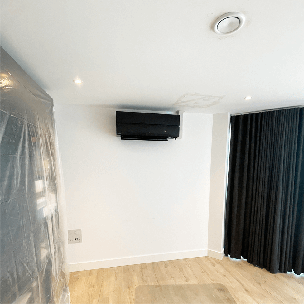 Dark wall-mounted air conditioning unit in a finished room